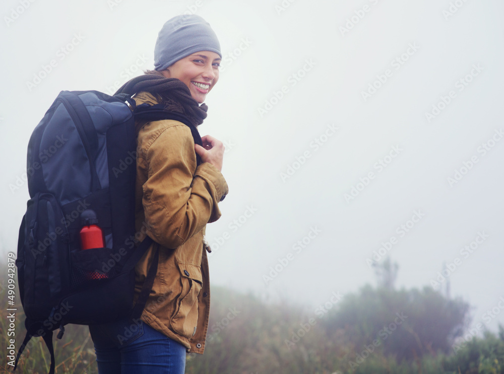 你应该和我一起……一位年轻女子在阴天沿着小路徒步旅行的肖像。