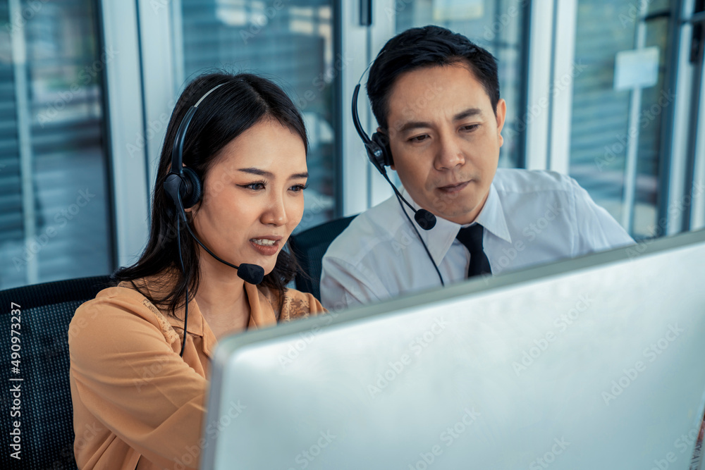 Business people wearing headset working actively in office . Call center, telemarketing, customer su