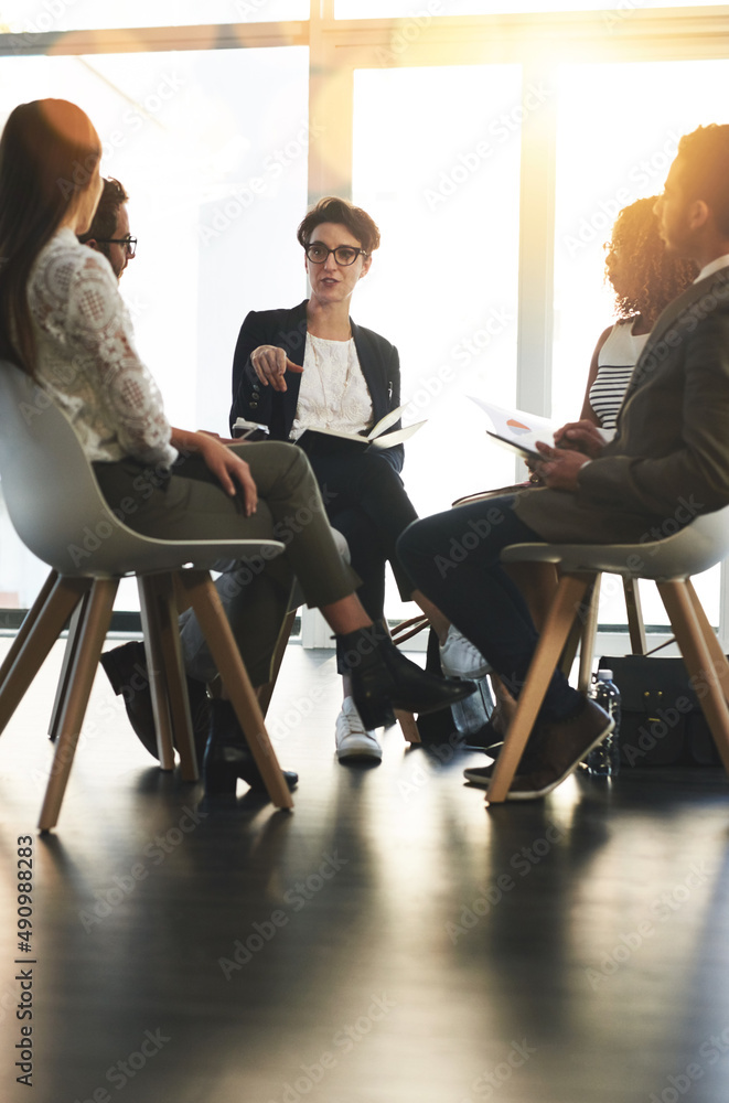 Talking serious business. Shot of a group of corporate businesspeople sitting in a meeting.