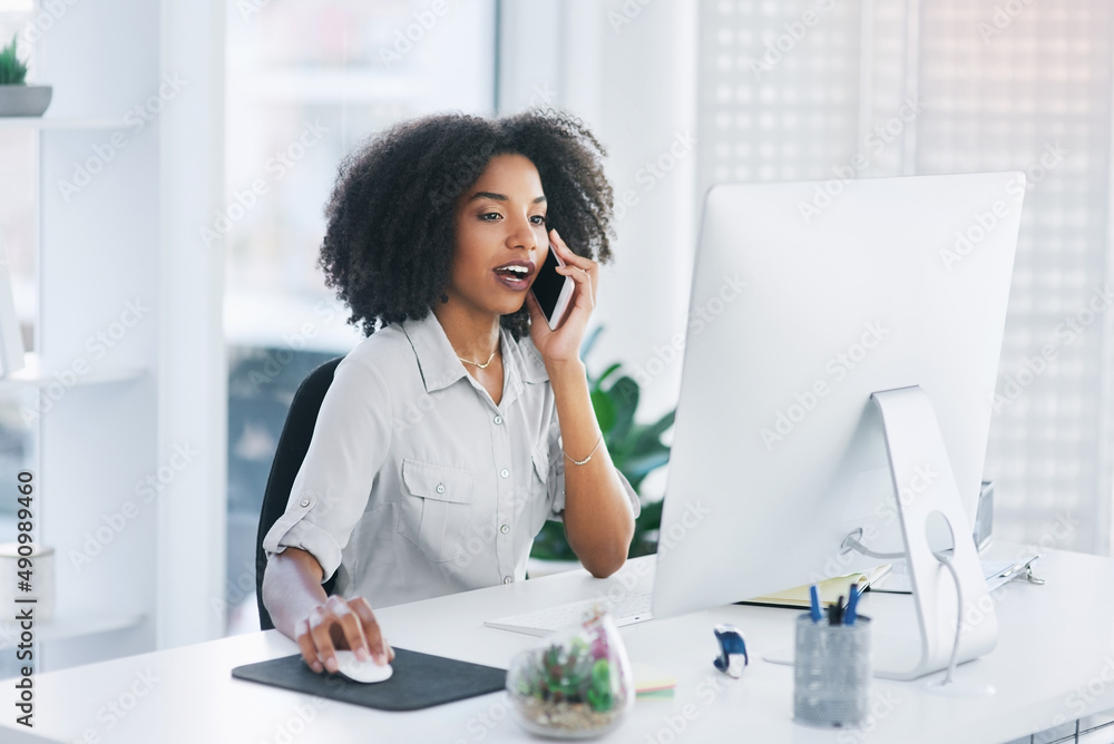 Let me just open the document on my pc.... Shot of a young businesswoman talking on a cellphone in a