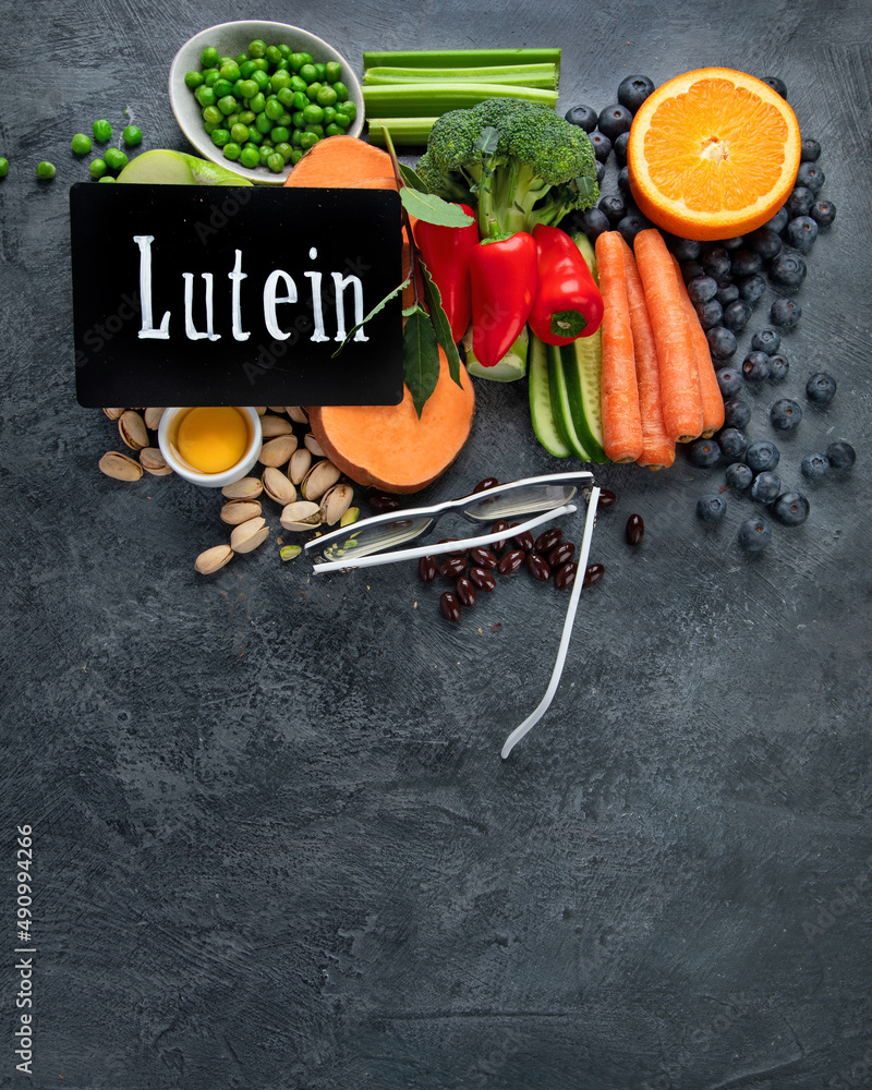 Foods high in lutein on dark background.