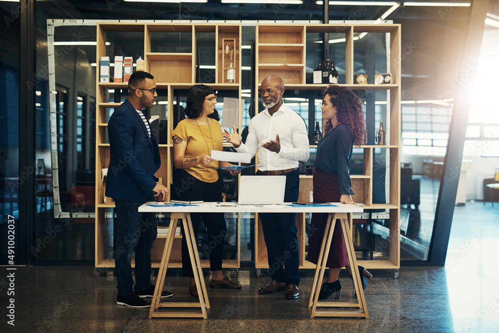 Planning brings everyone together. Shot of a group of designers having a discussion in a modern offi