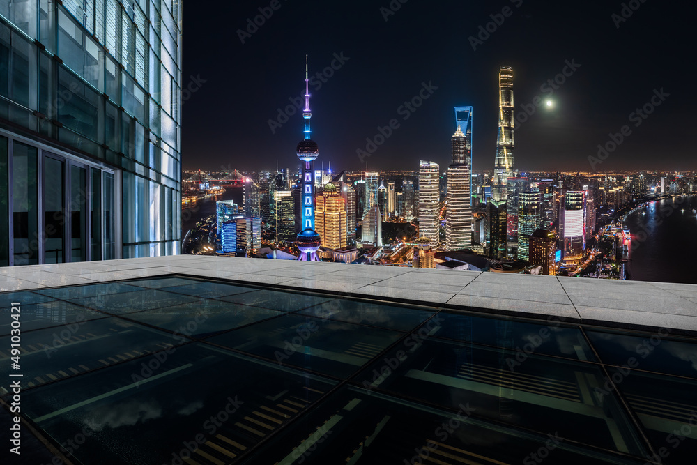 Empty square floor and city skyline with buildings in Shanghai at night, China.