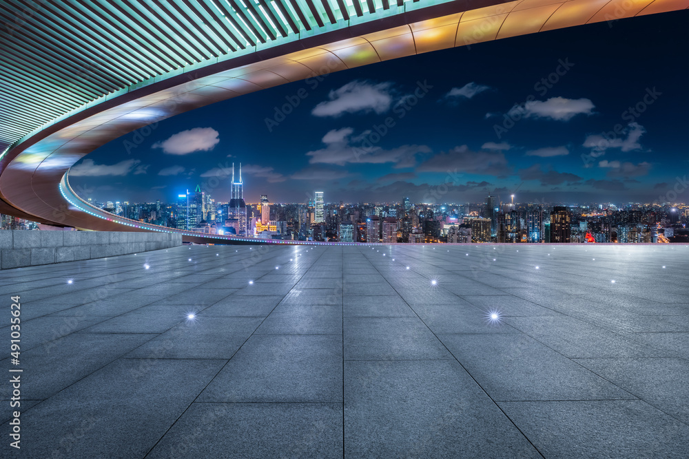 Empty square floor and city skyline with buildings in Shanghai at night, China.