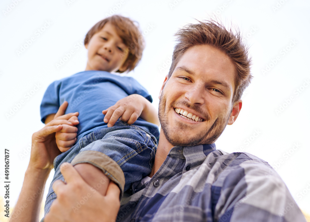 Ill carry him to greatness. Portrait of a young father carrying his son on his shoulders.