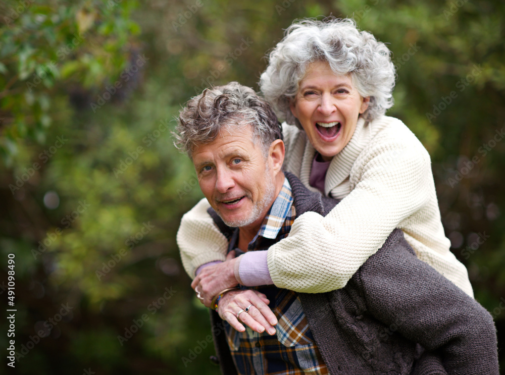 Golden moments together. Shot of a loving senior couple being playful outside.