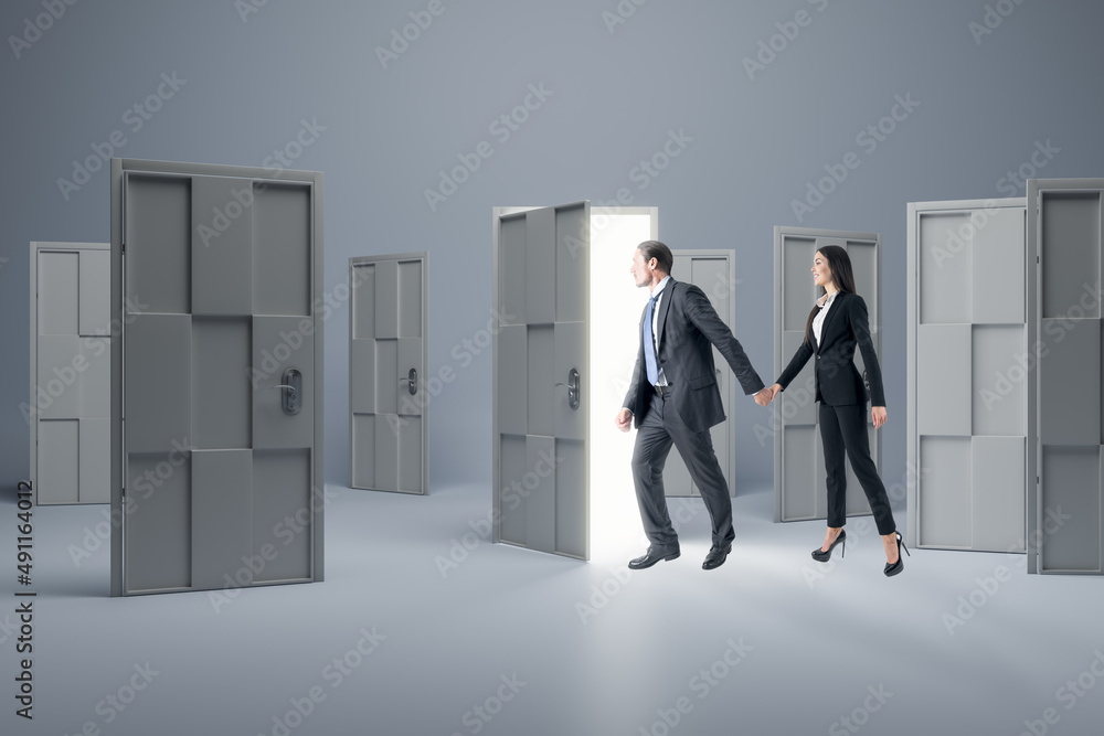 Businessman and woman standing in front of abstract white puzzle door in interior. Future, teamwork,