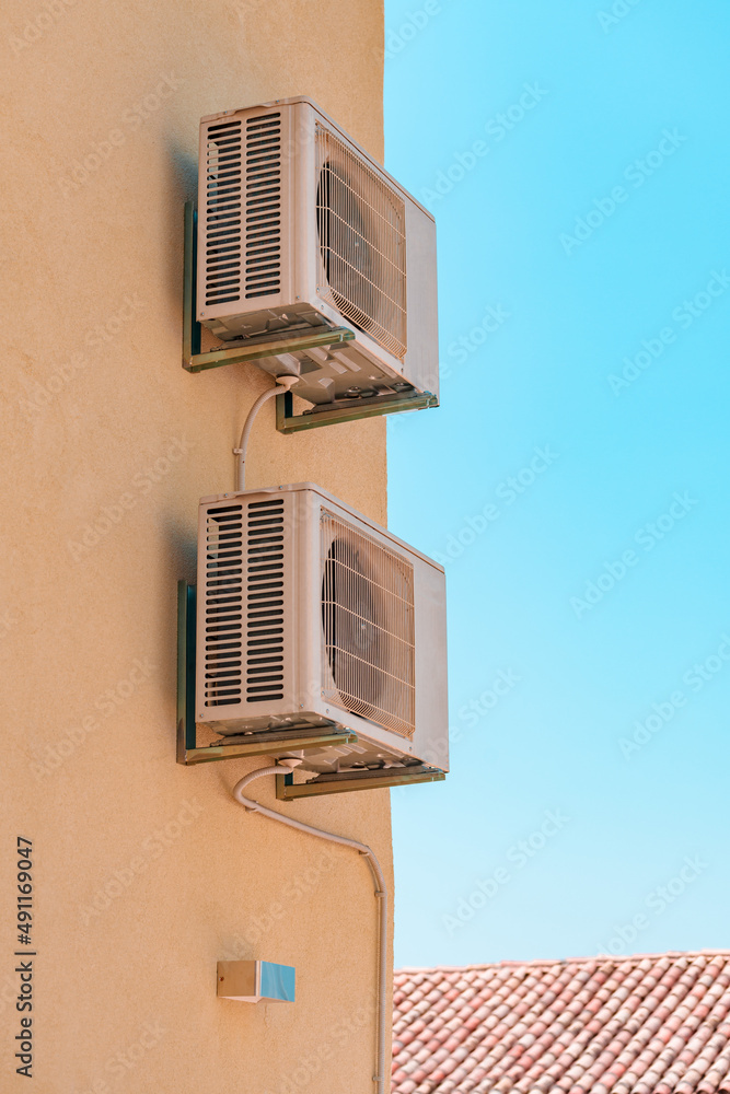 Air conditioner external unit mounted on the wall of mediterranean house in Croatia