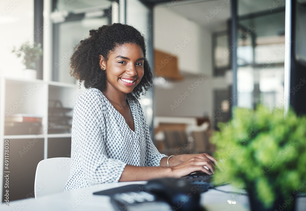 Ive got many ambitious dreams to work towards. Portrait of a young businesswoman working on a comput