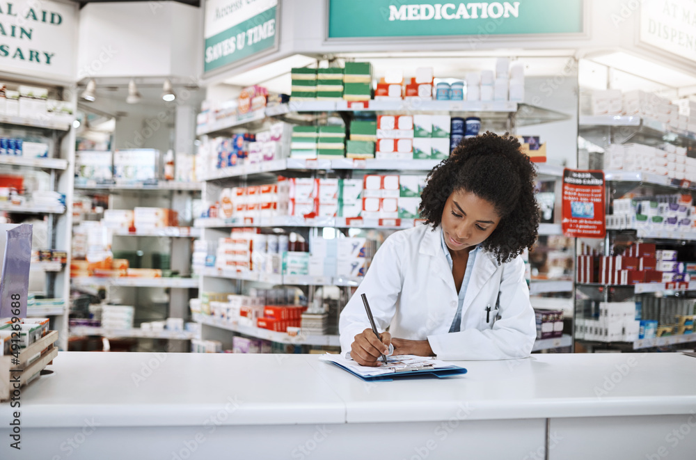 Ill leave you some instructions. Cropped shot of an attractive young female pharmacist working in a 