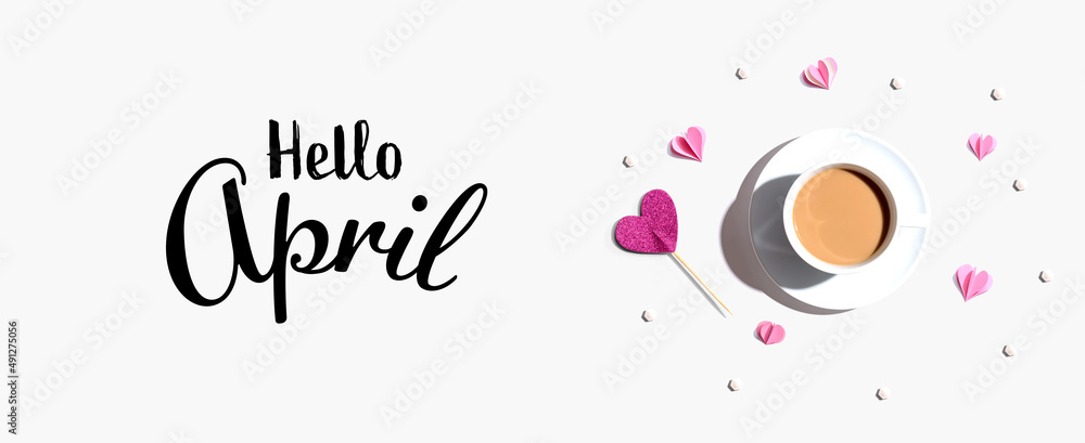 Hello April message with a cup of coffee and paper hearts - flat lay