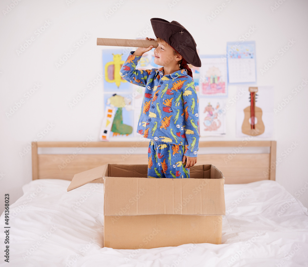 Is that a whale. A little boy playing pirate in a cardboard box.