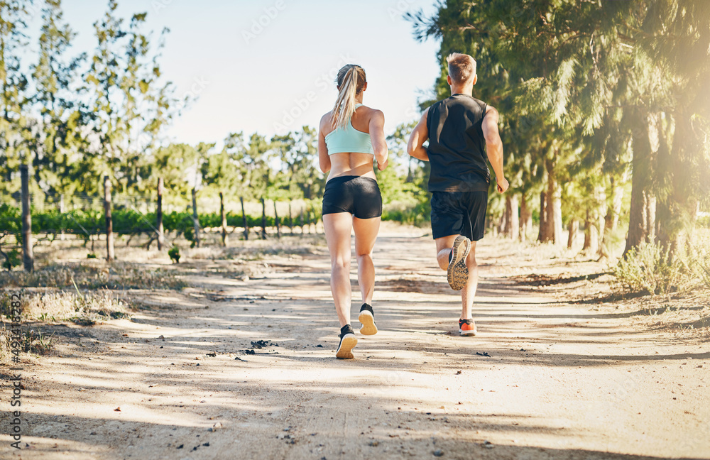 Live Love Run. Rearview shot of a young couple running together outdoors.