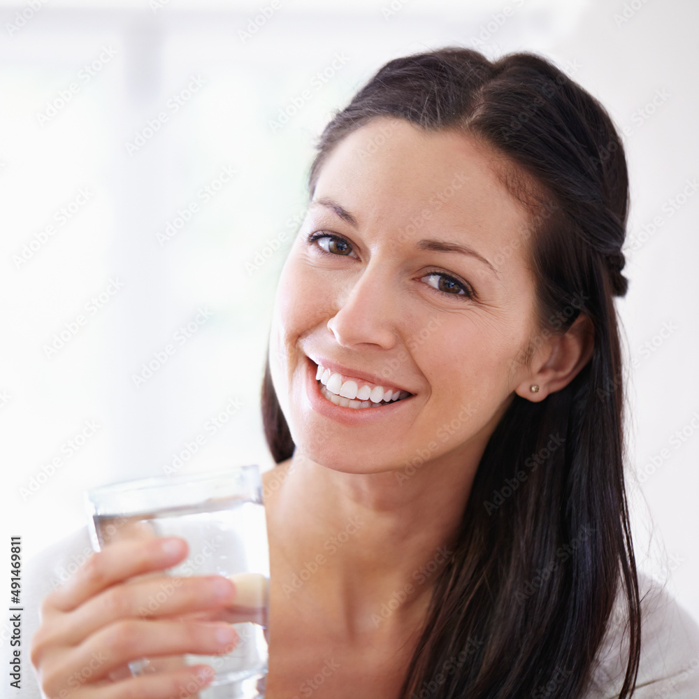 You should drink at least 8 glasses per day. Cropped portrait of an attractive young woman drinking 