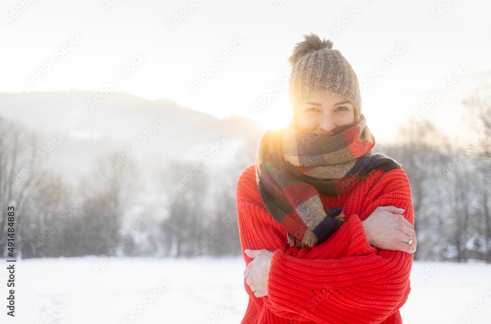 Happy girl in winter clothes portrait snowy outdoor during sunny day