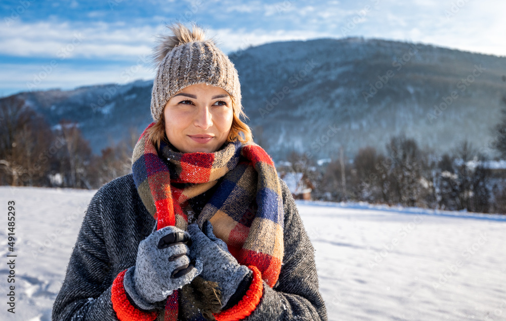 Winter portrait outdoor beautiful woman wearing woolen sweater hat and scarf