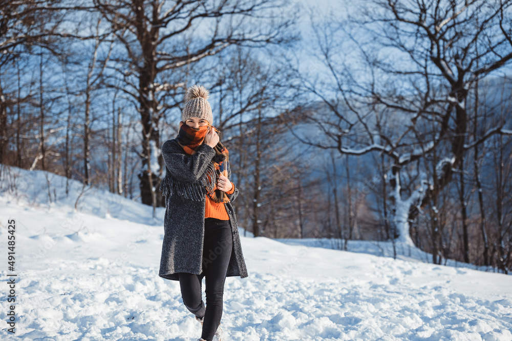 Winter portrait outdoor beautiful woman wearing woolen sweater hat and scarf