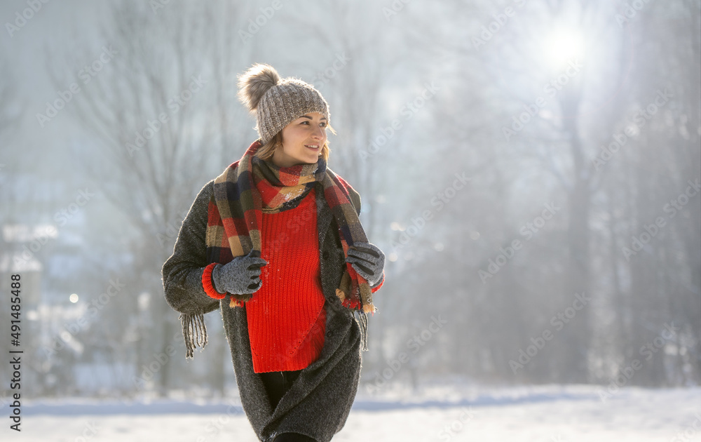 Winter portrait outdoor beautiful woman wearing woolen sweater hat and scarf