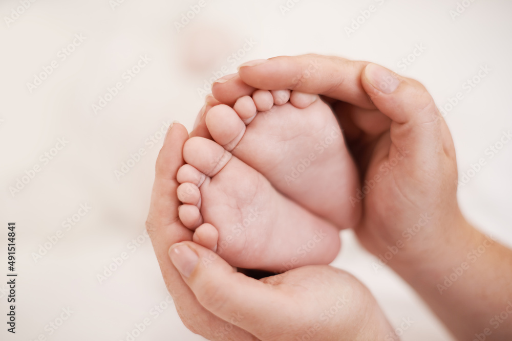 Such tiny little feet. Cropped shot of mother holding her babies feet.