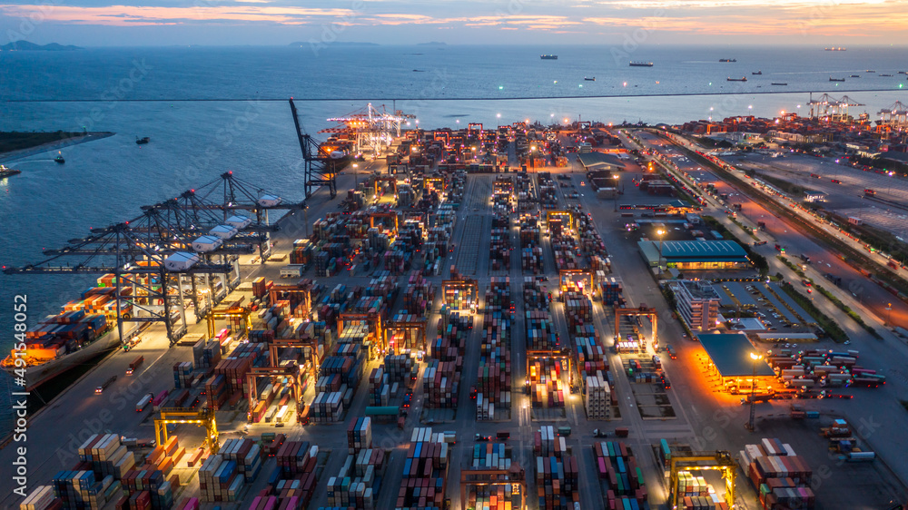 Container ship loading and unloading in deep sea port, Aerial view business commercial trading logis