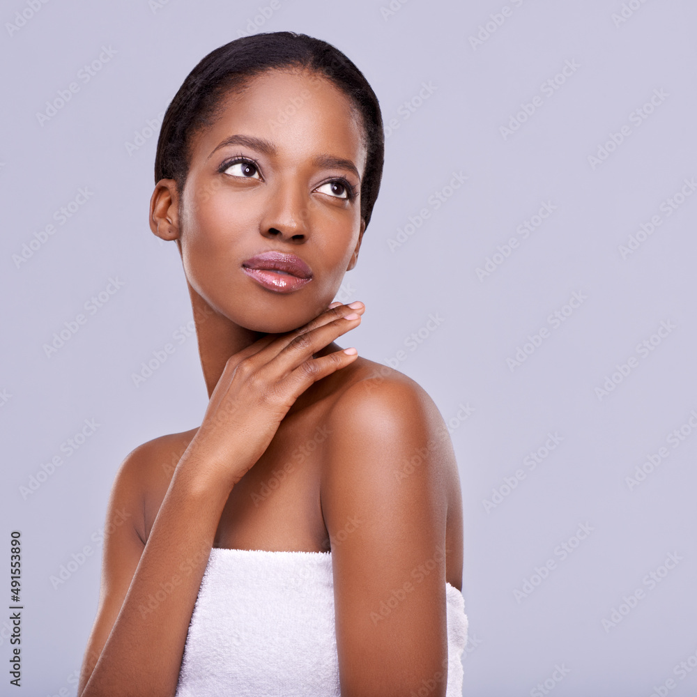 Enhancing her natural beauty. Cropped shot of a beautiful young woman against a purple background.