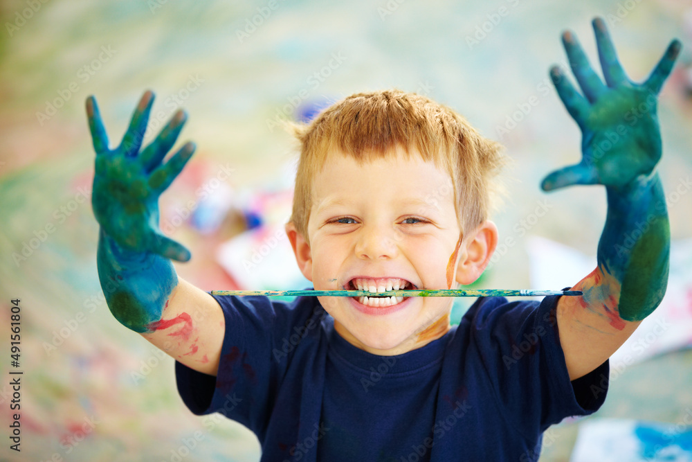 Messy little artist. A little boy covered in paint.