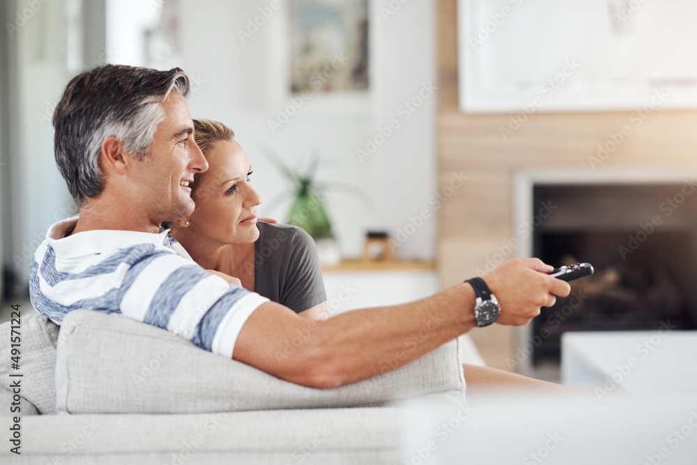 Another episode. Cropped shot of an affectionate mature couple cuddling on the sofa while watching m