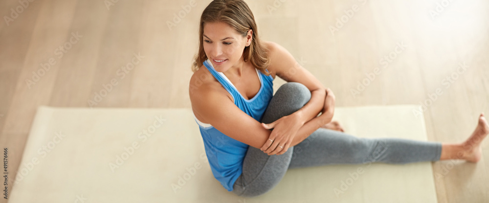 Staying strong, supple and flexible. Shot of a young woman doing yoga at home.