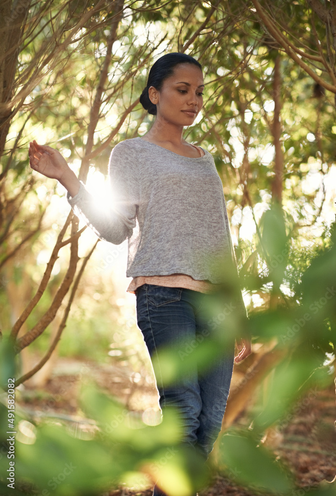 Taking in nature. A young woman enjoying a walk in the woods.