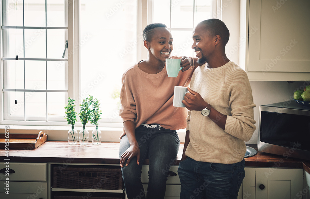 Were staring off our day on a warm note. Shot of a happy young couple drinking coffee and spending t