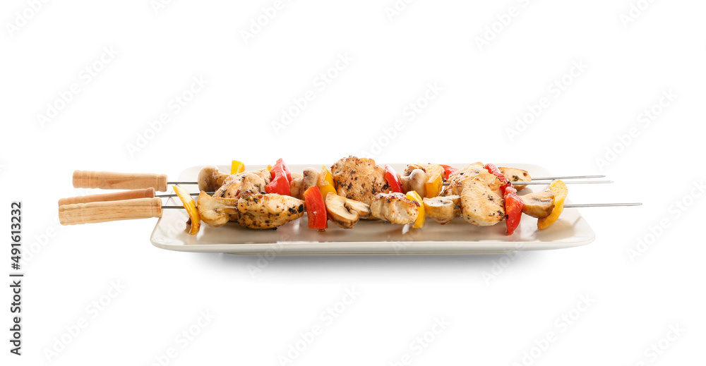 Plate of grilled chicken skewers with vegetables isolated on white background