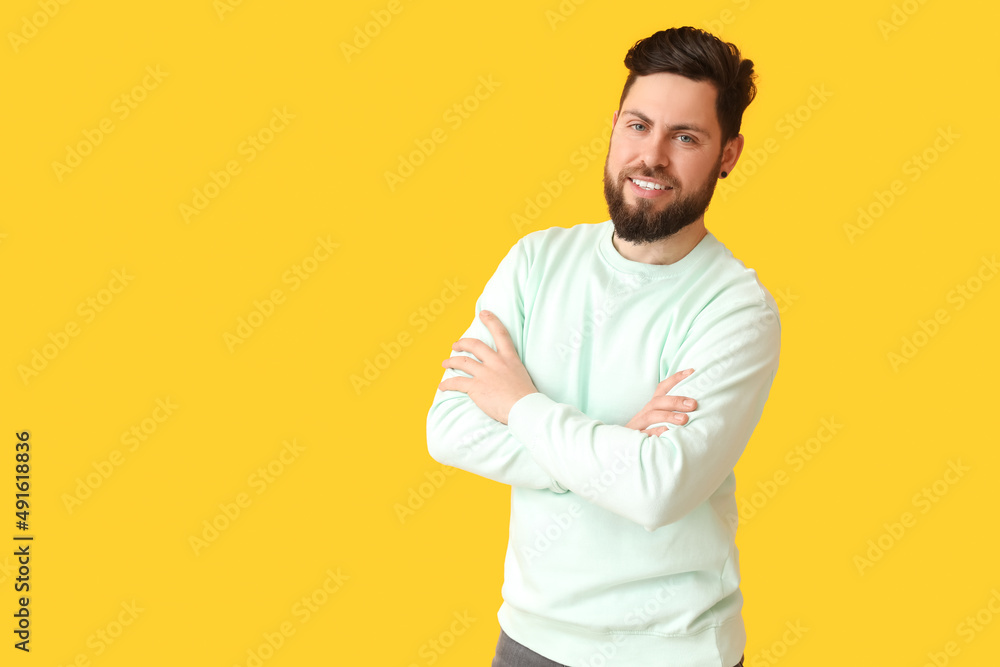 Stylish bearded man on yellow background