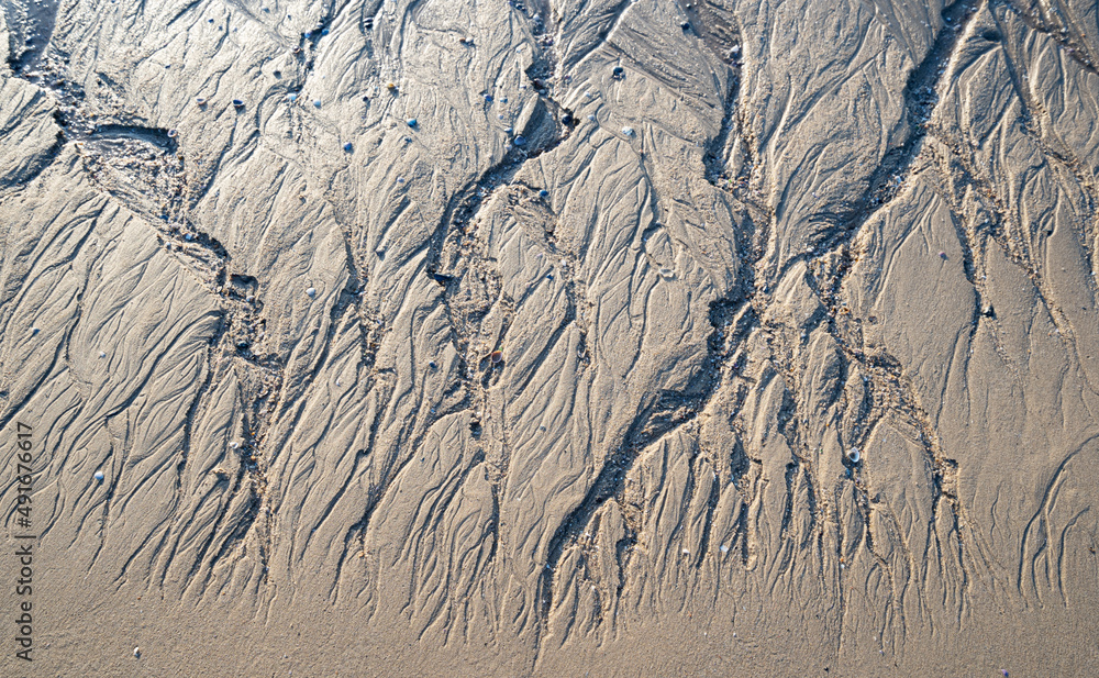 Patterns on sandy beach after low tide on the ocean.abstract sand nature background. Close up of pat