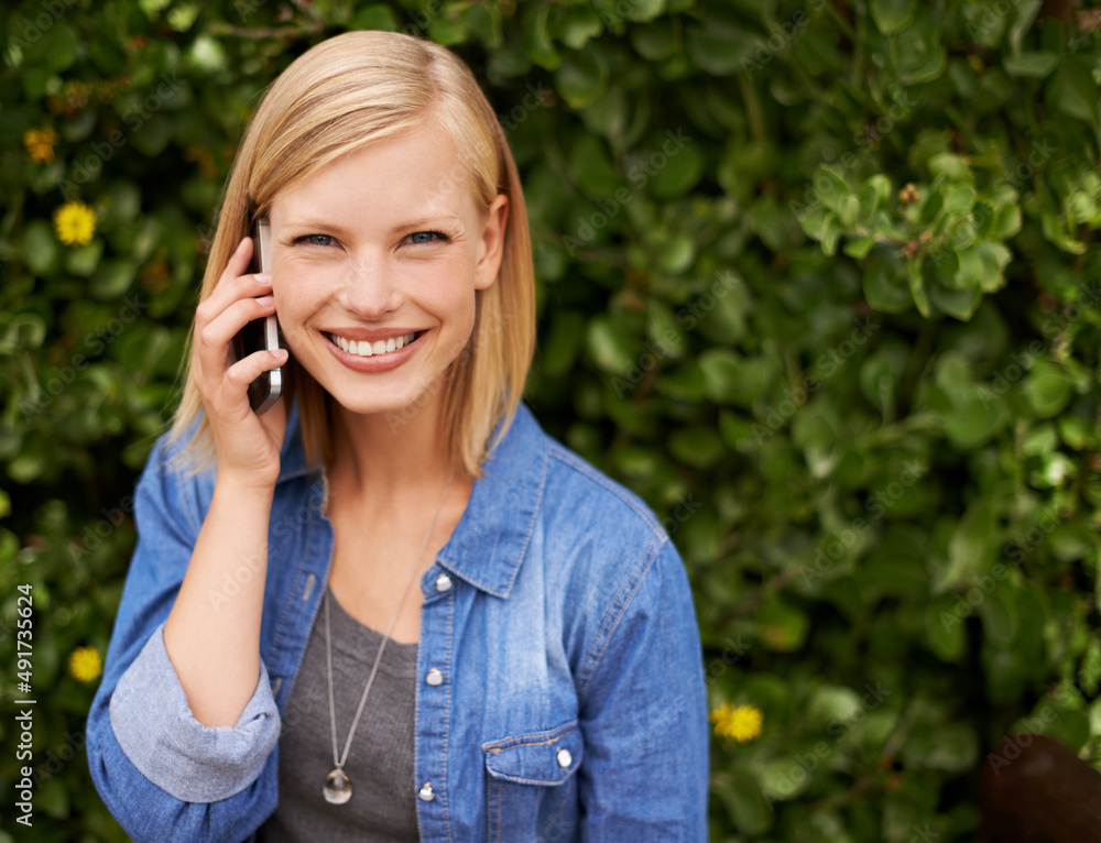 Care to join me in the park. Cropped shot of an attractive blonde woman talking on her phone in the 