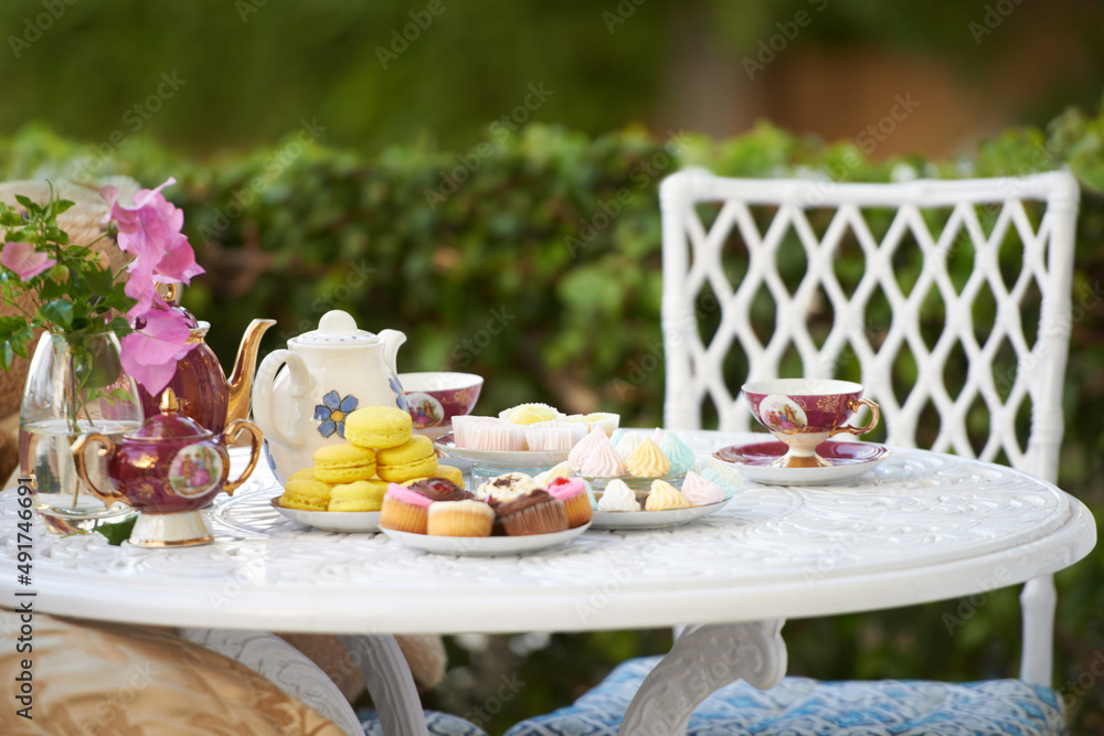 High tea. A table decked out with tasty treats and tea.