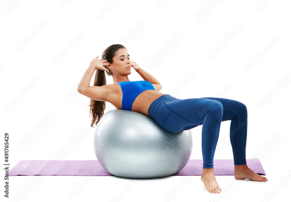 Working on her core. Shot of a sporty young woman practising yoga against a white background.