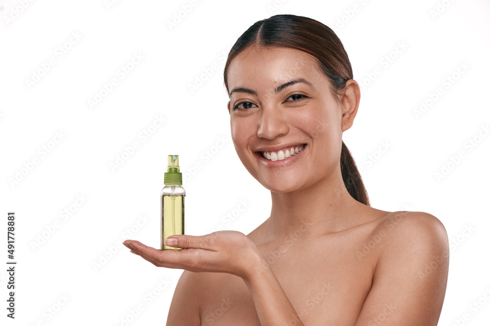 It helps keep your face fresh for longer. Shot of a beautiful young woman holding up a bottle of fac