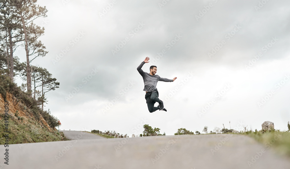 I just beat my own record. Full length shot of a handsome young man jumping for joy after his mornin