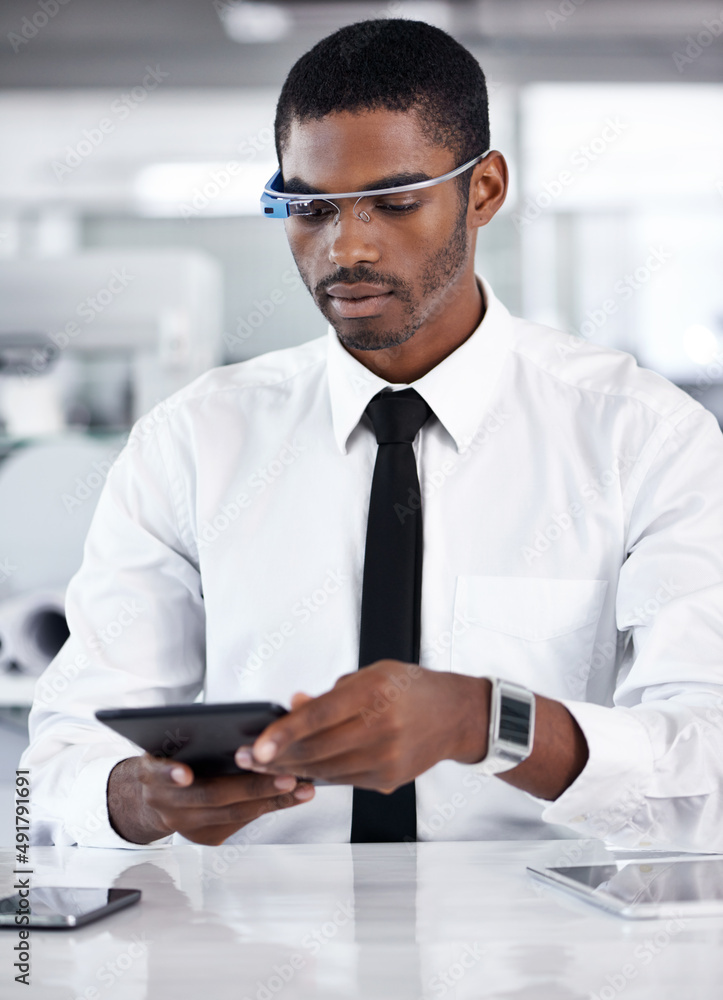 Wireless is the only way to work. Cropped shot of a handsome young businessman using smartglasses in