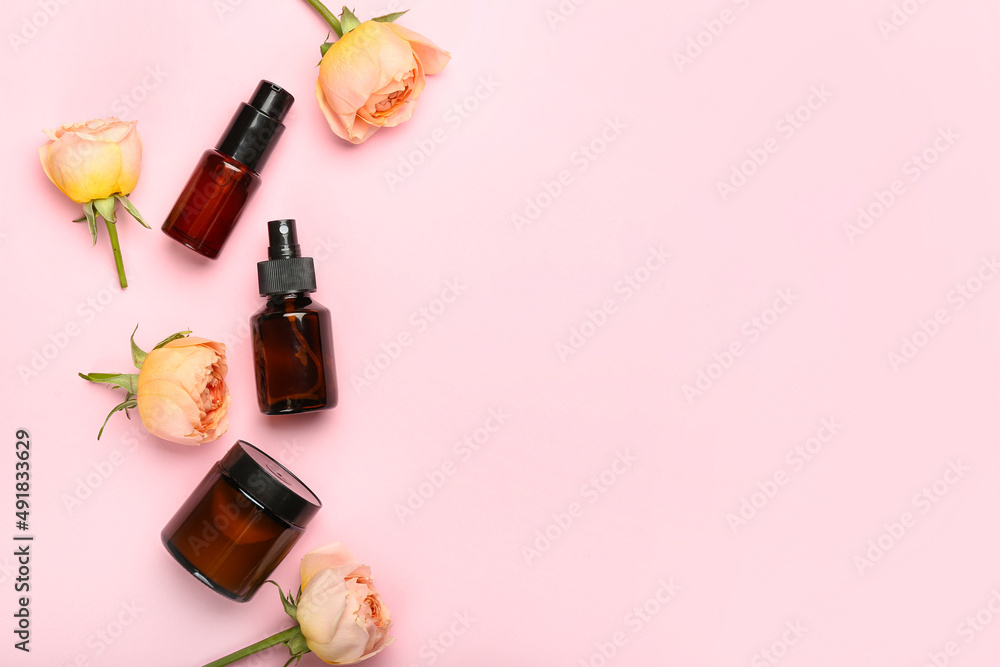 Cosmetic products and beautiful rose flowers on pink background