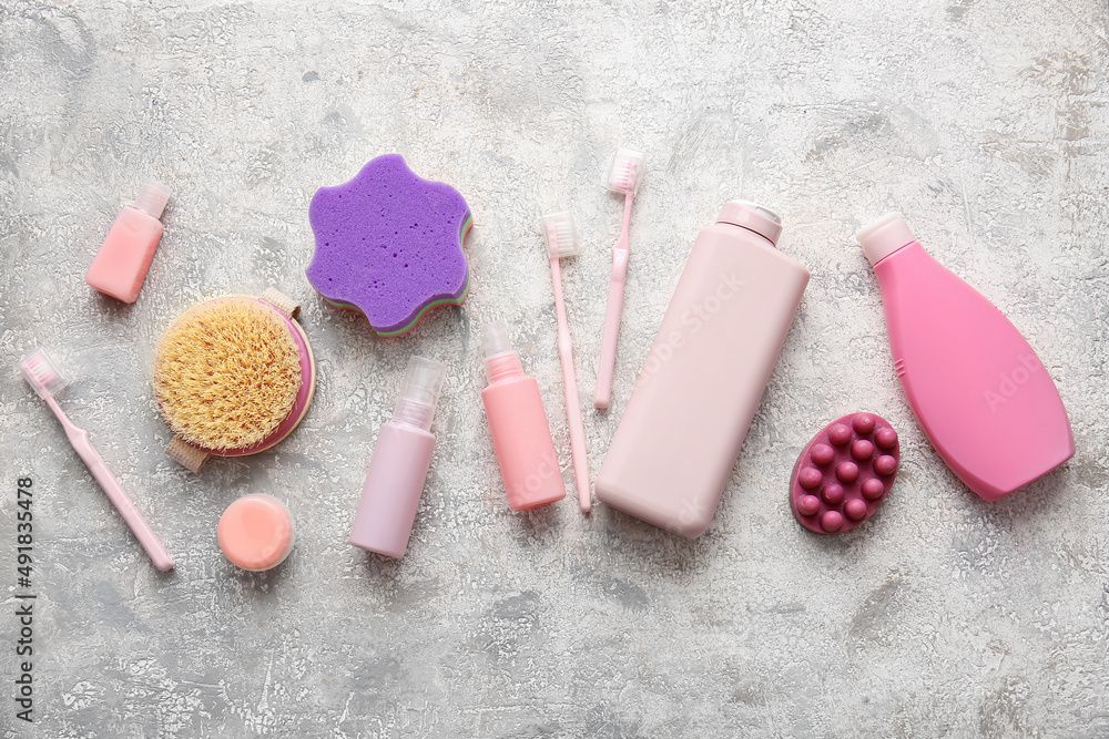 Different cosmetic products and bath supplies on light background