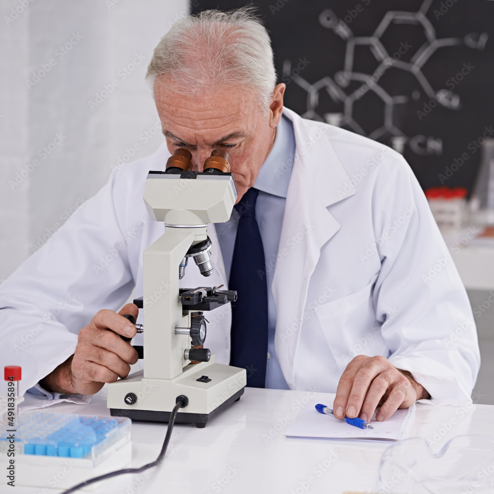 Breaking discoveries in the lab. Shot of a mature scientist using a microscope.