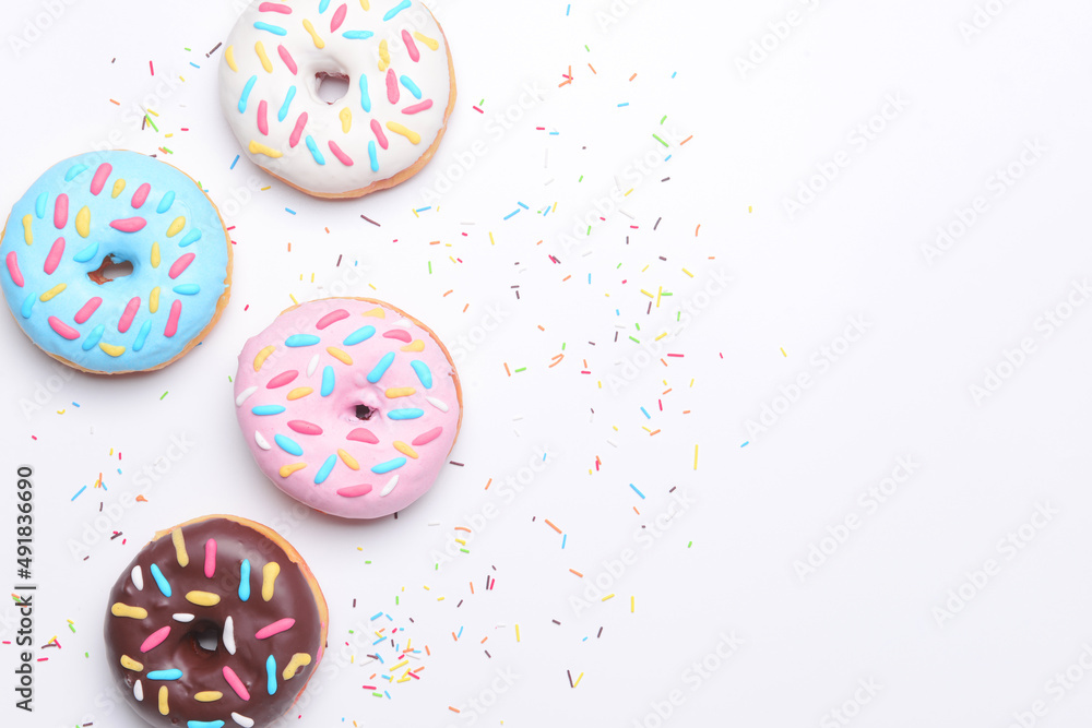 Different delicious donuts on white background