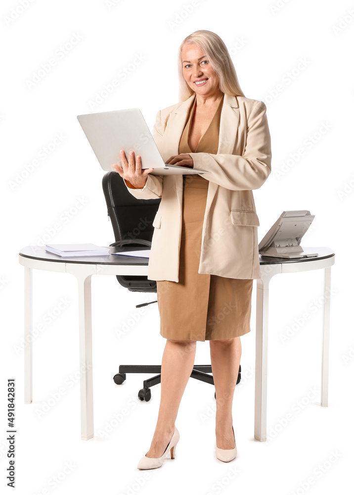 Mature secretary with laptop near her workplace on white background