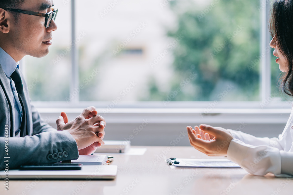 Asian male director is interviewing to recruit new employees