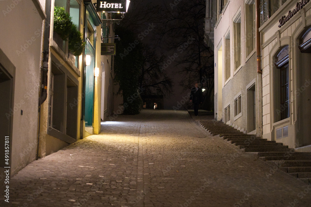 Alley at the old medieval old town of Zürich on a dark winter night. Photo taken February 24th, 2022