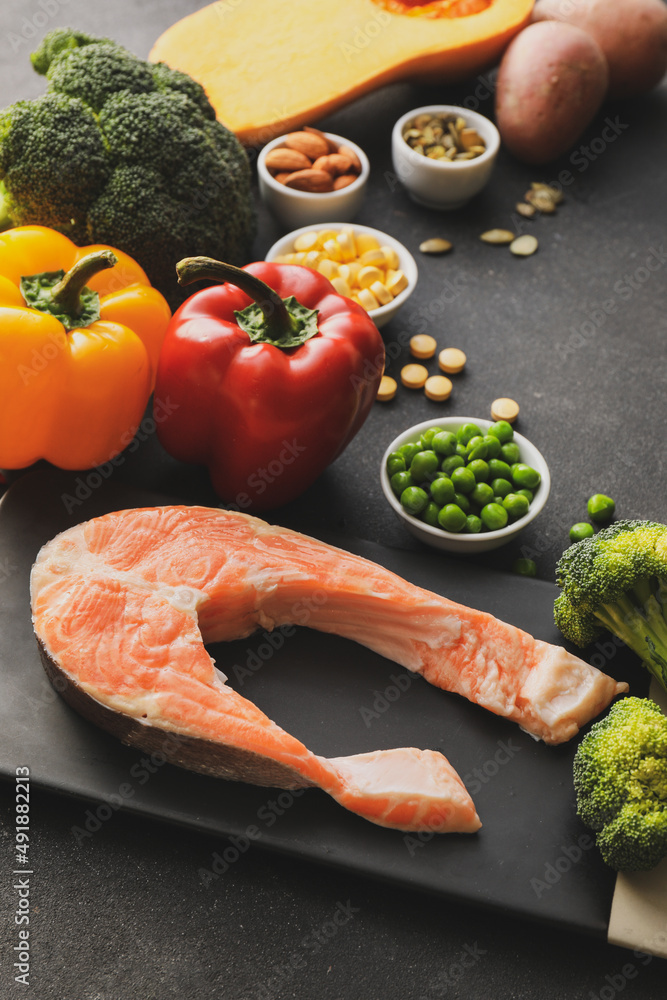 Set of healthy products with pills on dark background