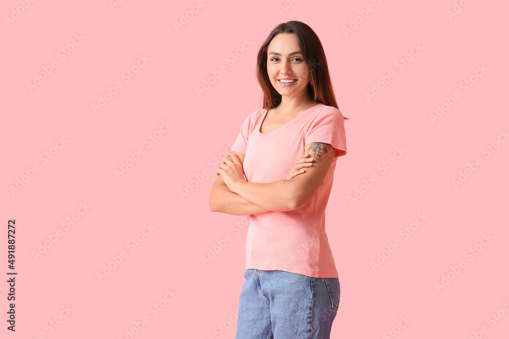 Young woman in blank t-shirt on color background