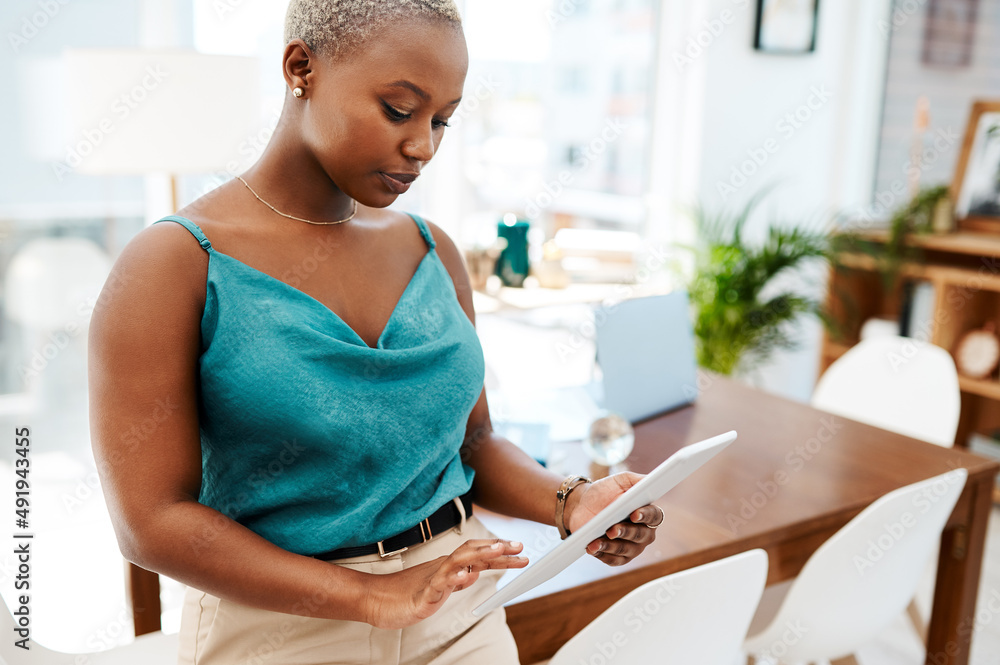 Whatever the task, technology will take care of it. Shot of a young businesswoman using a digital ta