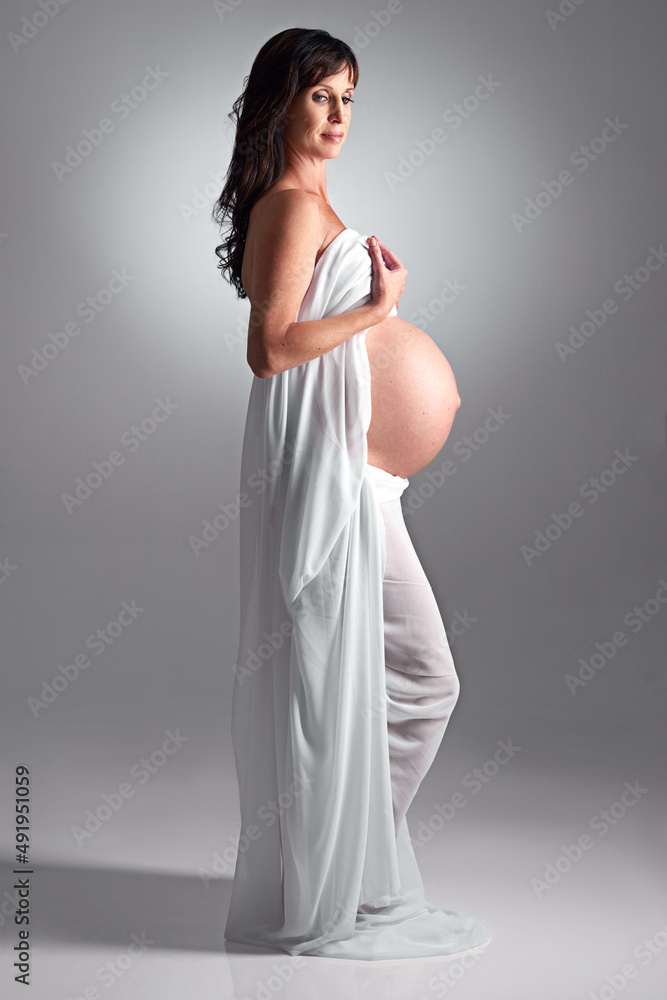 Expecting her arrival soon. A pregnant woman holding her tummy.